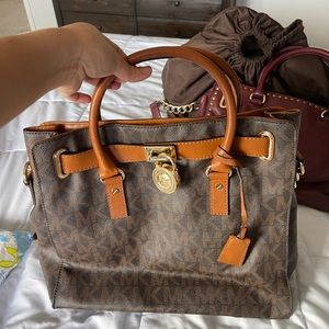 Micheal kors monogram leather satchel with gold lock